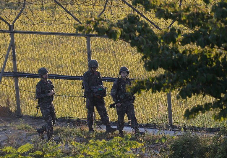 South Korean army soldiers patrol through the wire fences near the demilitarized zone between the two Koreas in Paju, South Korea, Tuesday, Oct. 7, 2014. Warships from the rival Koreas exchanged warning shots Tuesday after a North Korean ship briefly violated the disputed western sea boundary, a South Korean defense official said. (AP Photo/Ahn Young-joon)