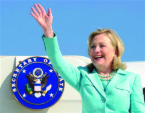 In this June 10, 2011 file photo, Secretary of State Hillary Rodham Clinton waves as the arrives at Lusaka International Airport in Lusaka, Zambia. (AP Photo/Susan Walsh)