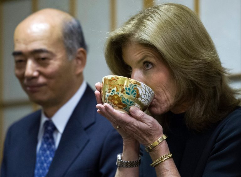 Japanese Ambassador to the United States His Excellency Kenichiro Sasae, left, watches as U.S. Ambassador to Japan Caroline Kennedy drinks a cup of tea during a traditional tea ceremony at the Japanese Ambassador's residence in Washington, Tuesday, Nov. 12, 2013. Kennedy, the new U.S. ambassador to Japan and daughter of slain President John F. Kennedy, leaves for Japan on Thursday to begin her work to strengthen the critical bond between the U.S. and the Asian nation. (AP Photo/Cliff Owen)