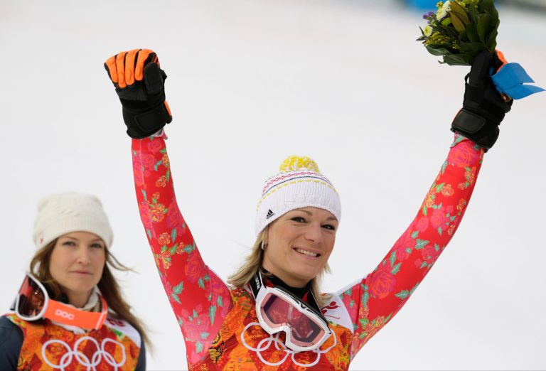 Women's supercombined gold medal winner Germany's Maria Hoefl-Riesch and bronze medal winner United States' Julia Mancuso celebrate after a flower ceremony at the Sochi 2014 Winter Olympics, Monday, Feb. 10, 2014, in Krasnaya Polyana, Russia. (AP Photo/Charles Krupa)