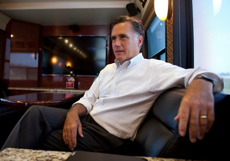   FILE -In this June 8, 2012 file photo, Republican presidential candidate, former Massachusetts Gov. Mitt Romney talks with his staff while riding on his bus after a campaign stop in Council Bluffs, Iowa. Keeping his secrets, Romney tends to lift the veil on his finances and campaign only if the law says he must. The Republican presidential candidate refuses to identify his biggest donors who 