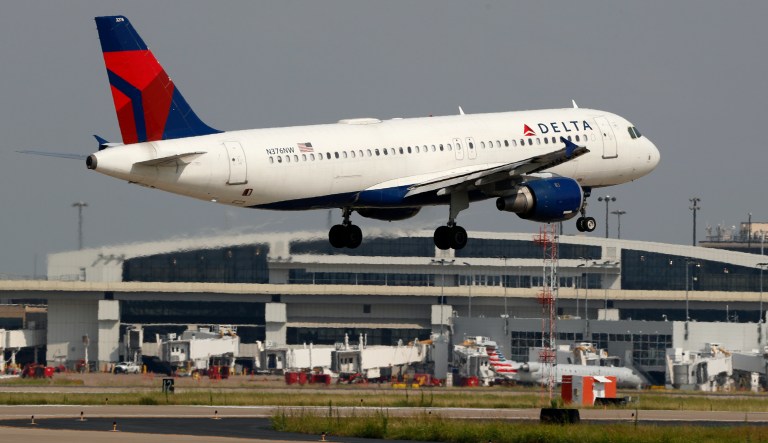 FILE - In this June 24, 2019, file photo a Delta Air Lines aircraft makes its approach at Dallas-Fort Worth International Airport in Grapevine, Texas. Delta Air Lines reports earns Tuesday, Oct. 8.