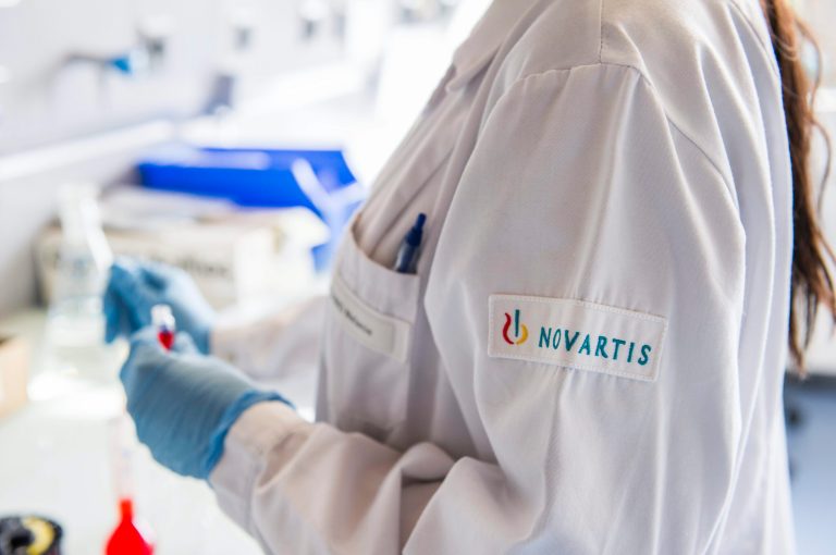 FILE - The Oct. 19, 2012 file photo shows a Novartis employee in a laboratory of Novartis in Prangins near Nyon, Switzerland. Swiss pharmaceutical giant Novartis AG announced a series of multibillion-dollar deals Tuesday, April 22, 2014 with other major pharmaceutical companies that it said would reduce sales but boost profitability, while affecting some 15,000 of its employees globally.  (AP Photo/Keystone, Yannick Bailly)