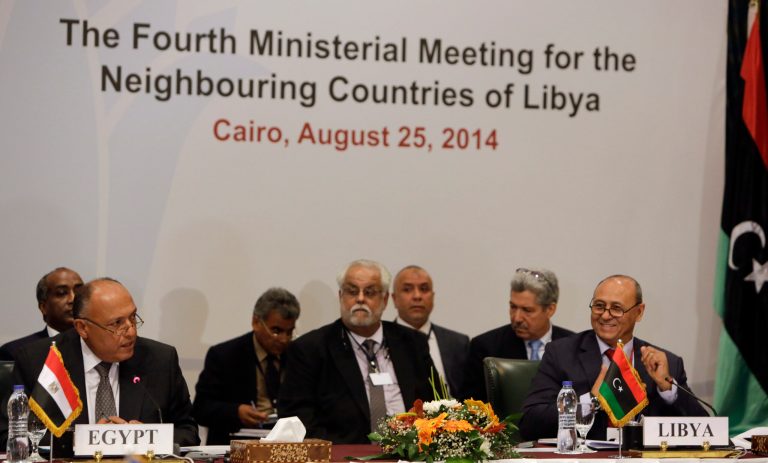Libyan Foreign Minister Mohamed Abdelaziz, right, listens to his Egyptian counterpart Sameh Shukri, left, during the opening session of The Fourth Ministerial Meeting for the Neighbouring Countries of Libya, in Cairo, Egypt, Monday, Aug. 25, 2014. Foreign ministers from Egypt, Libya, Algeria, Tunisia, Sudan, Chad, as well as the Arab League Secretary General met Monday in Cairo as Islamist-led militias in the Libyan capital say they consolidated their hold on Tripoli and its international airport, driving out rivals to the city's outskirts after battles that largely destroyed the strategic hub. (AP Photo/Amr Nabil)