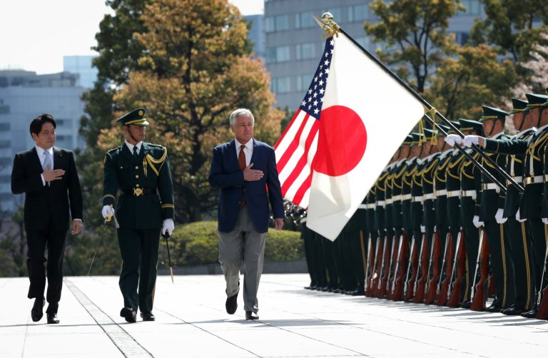 U.S. Secretary of Defense Chuck Hagel, right, reviews honor guards accompanied by Japanese Defense Minister Itsunori Onodera, left,  at the Japanese Ministry of Defense headquarters Sunday, April 6, 2014 in Tokyo, Japan. Secretary Hagel is visiting Japan, China and Mongolia, his fourth trip to Asian nations since taking office.  (AP Photo/Alex Wong, Pool)