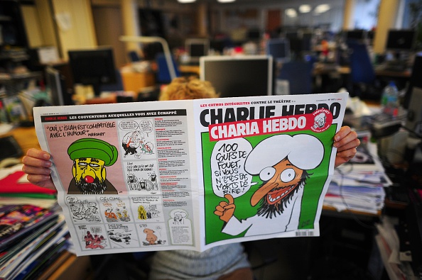 A person reads on November 1, 2011 in Paris an issue of Satirical French magazine Charlie Hebdo to be published on November 2, 2011, whose cover features prophet Mohammed. (MARTIN BUREAU/AFP/Getty images)