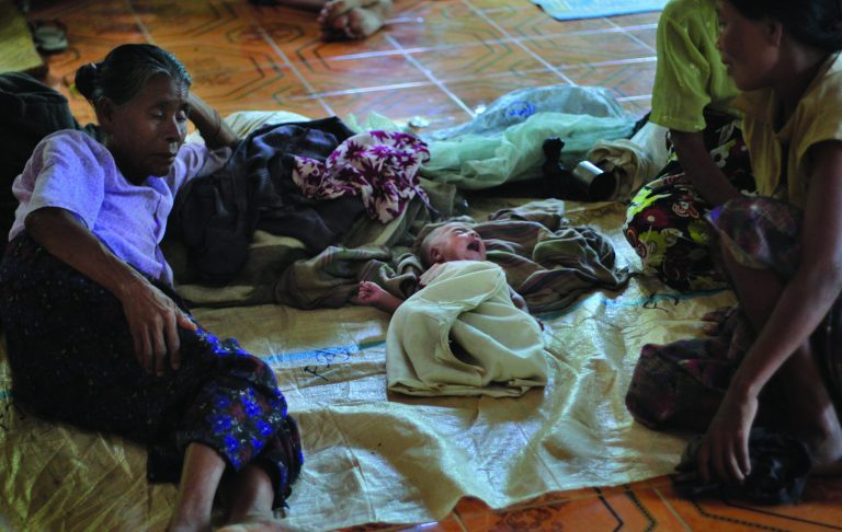 In this photo taken on Nov. 8, 2012, Ethnic Rakhine people take refuge at a monastery in Mrauk-U, Rakhine state, western Myanmar. Mrauk-U itself has been spared the bloodshed between the Buddhist Rakhine and the Muslim Rohingya that has scarred other parts of Rakhine state. It is calm, and for foreign tourists, safe. But just 10 kilometers (six miles) to the south, there is a village where civilians were reportedly beheaded in a massacre last month that saw women and children slaughtered, then buried in mass graves. Across western Myanmar's Rakhine state, the United Nations is distributing emergency supplies of food and shelter to terrified villagers who have fled burning homes. A nighttime curfew is in force. (AP Photo/Khin Maung Win)