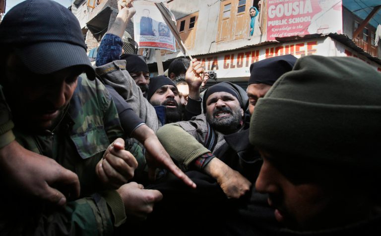 Activists of Jammu and Kashmir Liberation Front (JKLF) scuffle with policemen as they are detained during a protest in Srinagar, India, Sunday, Feb. 9, 2014. Thousands of Indian troops fanned out across Indian-controlled Kashmir on Sunday, detaining about 200 separatist activists to prevent protests during a three-day strike to mark the execution anniversaries of two separatists in New Delhi, officials said. (AP Photo/Mukhtar Khan)