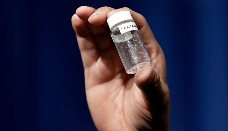 In this 2017 photo, a reporter holds up an example of the amount of fentanyl that can be deadly after a news conference about deaths from fentanyl exposure, at Drug Enforcement Administration Headquarters in Arlington, Va. A Homeland Security reauthorization bill includes two amendments that seek to plug holes in the international mail system that make it easy for drug traffickers to ship synthetic drugs such as fentanyl to the U.S. (AP Photo/Jacquelyn Martin, File)