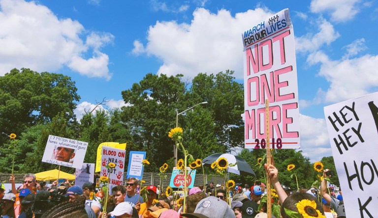 Protesters in favor of gun control march outside of the National Rifle Association's headquarters in Fairfax, Va.