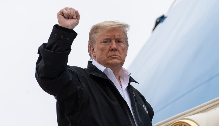 President Donald Trump pumps his fist as he boards Air Force One during departure, Friday, March 6, 2020, at Andrews Air Force Base, Md.                