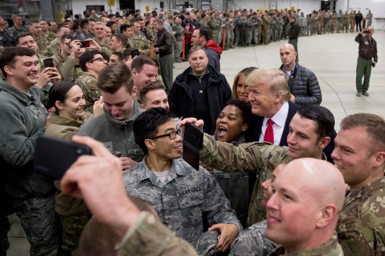 FILE - In this Thursday, Dec. 27, 2018 file photo, President Donald Trump, center right, and first lady Melania Trump, center left, greet members of the military at Ramstein Air Base, Germany. (AP Photo/Andrew Harnik)