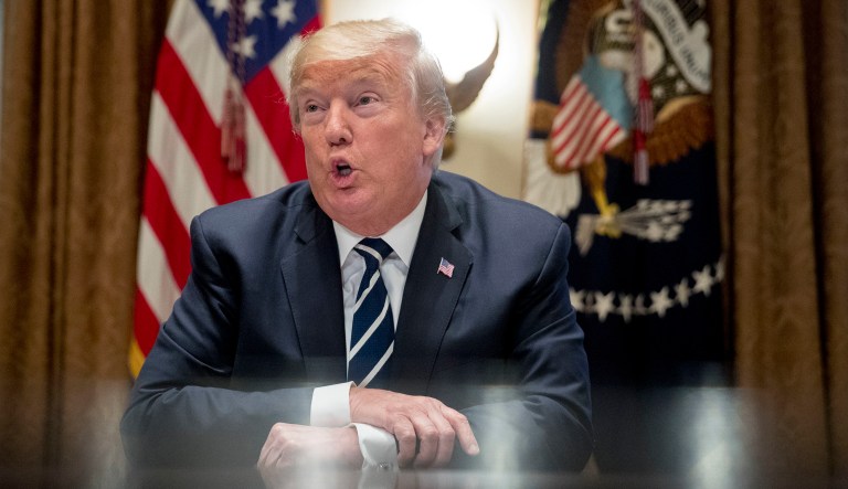 President Donald Trump speaks to members of the media as he meets with members of Congress in the Cabinet Room of the White House, Tuesday, July 17, 2018, in Washington. Trump says he meant the opposite when he said in Helsinki that he doesn't see why Russia would have interfered in the 2016 U.S. elections.