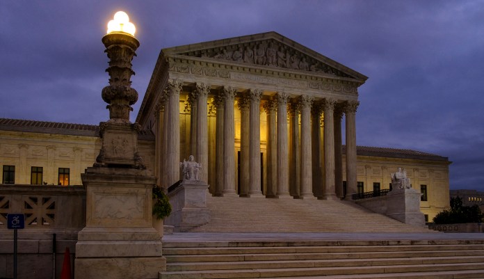 FILE - In this Oct. 5, 2018, file photo, the U. S. Supreme Court building stands quietly before dawn in Washington. 