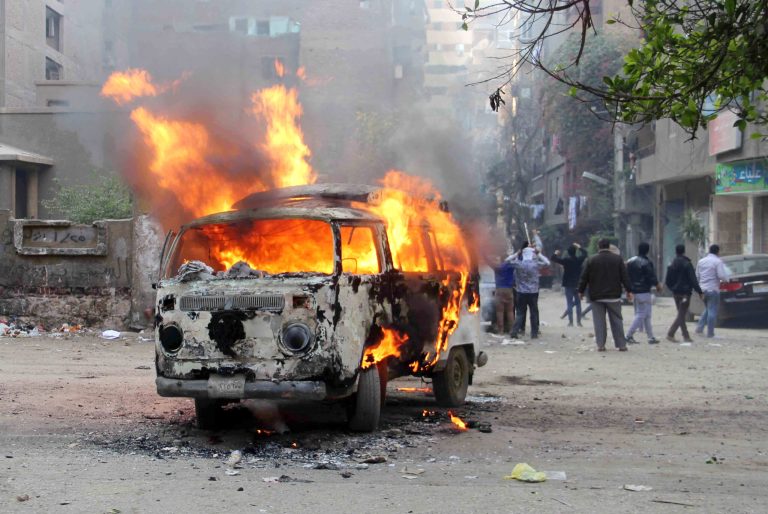 A Volkswagen van burns after being set on fire by supporters of ousted President Mohammed Morsi during clashes with security forces in Cairo, Egypt, Friday, Feb. 28, 2014. Hundreds of Morsi supporters took to the streets on Friday, the traditional Muslim day of prayer, to denounce the military-backed government and call on the release of their fellows detained during other demonstrations. They've been regularly protesting Friday since Morsi's overthrow. (AP Photo/Emad Abul Rahman)