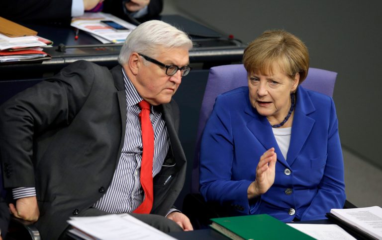 German Chancellor Angela Merkel, right, and German Foreign Minister Frank-Walter Steinmeier, left, talk during a meeting of the German federal parliament, Bundestag,  in Berlin, Germany, Thursday, Oct. 16, 2014. (AP Photo/Michael Sohn)