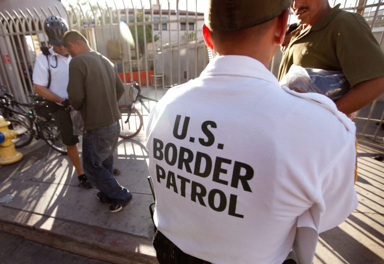 A U.S. Customs and Border Protection bike patrol agent assists Mexicans being returned to Mexico after they were apprehended for entering the United States illegally June 2, 2010 in Nogales, Ariz. (Photo by Scott Olson/Getty images)