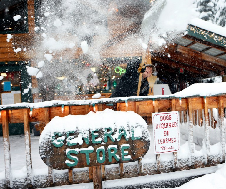   Don McLachlan shovels out from a winter snow storm at Shelter Cover Resort and Marina on Willamette Pass after a snow storm descended on the area Monday, Dec. 17, 2012. (AP Photo/The Register-Guard, Chris Pietsch)  