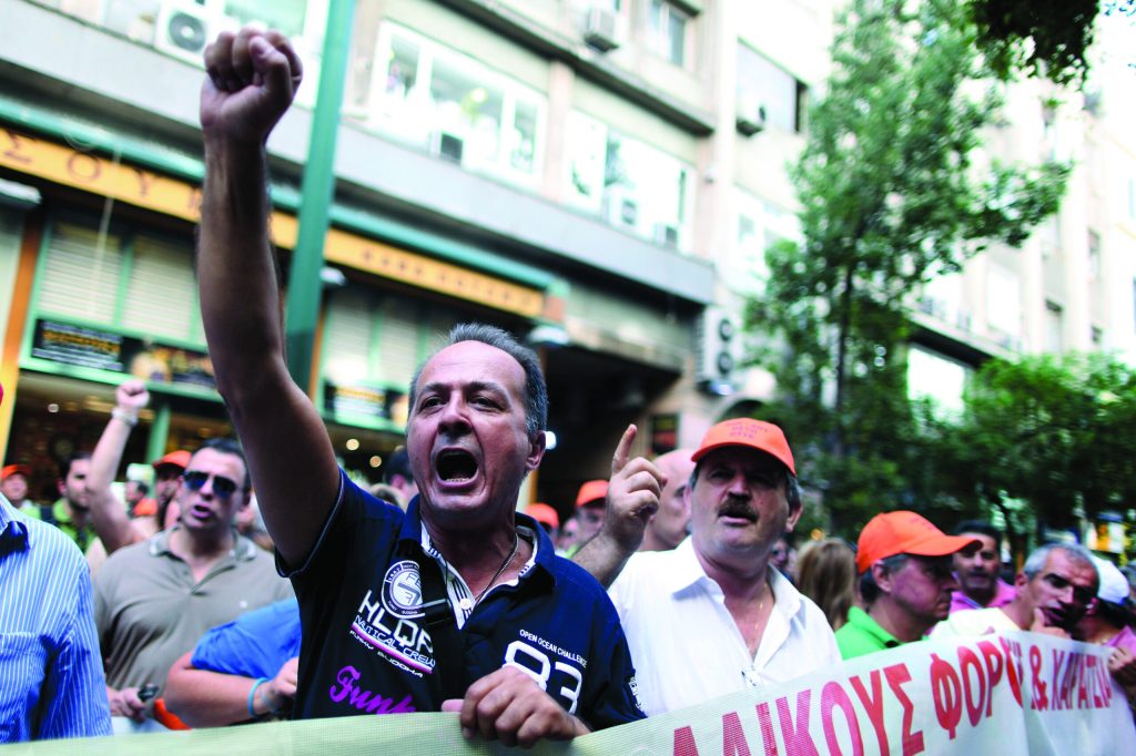 Spain, Greece launch austerity plans to secure aid