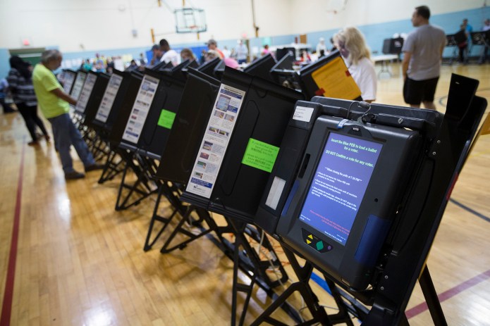"The U.S. election landscape is made up of approximately 9,000 different state and local jurisdictions, providing a patchwork of laws, standards, processes, and voting machines," Ian Gray, an intelligence analyst for the firm, noted in a blog post. "This environment is a formidable challenge to any actor, nation-state or not, who seeks to substantially influence or alter the outcome of an election." (AP Photo/John Minchillo)