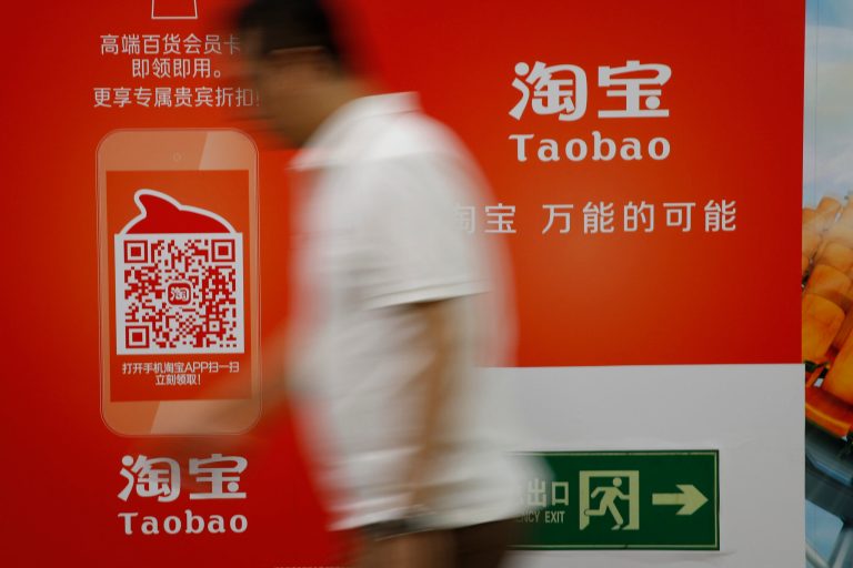 Chinese walking past a Taobao's mobile app advertisement billboard on display inside a subway station  in Beijing, China, Thursday, Sep 18, 2014. Alibaba Groupâs U.S. stock offering is a wakeup call about an emerging wave of technology giants in Chinaâs state-dominated economy. (AP Photo/Vincent Thian)