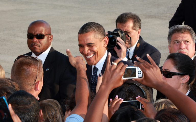 President Barack Obama greets well-wishers as he arrives at JFK International Airport in New York, Wednesday, Aug. 22, 2012, on his way to a visit in New York City where he attends several fundraiser events. (AP Photo/David Karp)