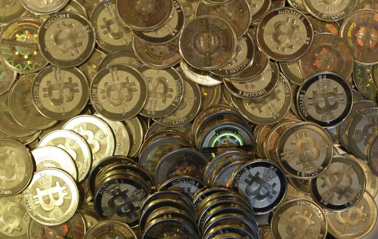 FILE - This April 3, 2013 file photo shows bitcoin tokens in Sandy, Utah. The Mt. Gox bitcoin exchange in Tokyo is headed for liquidation after a court rejected its bankruptcy protection application. Mt. Gox said Wednesday, April 16, 2014, the Tokyo District Court decided the company, which was a trading platform and storehouse for the bitcoin virtual currency, would not be able to resurrect itself under a business rehabilitation process filed for in February.  