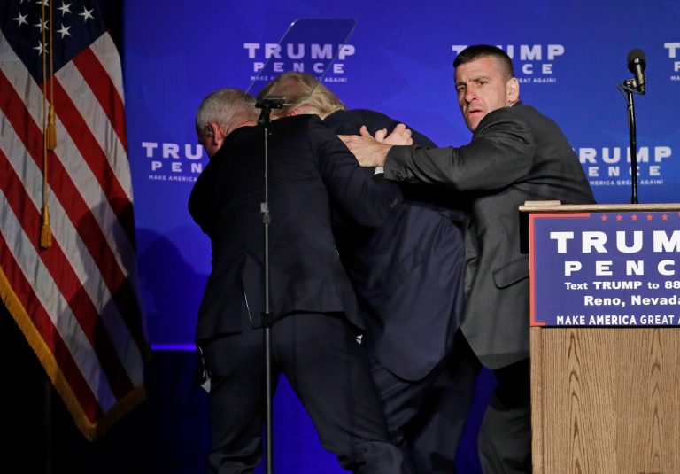 Secret Service agents rush Republican presidential candidate Donald Trump off the stage at a campaign rally in Reno, Nev., on Saturday, Nov. 5, 2016. A new book, 