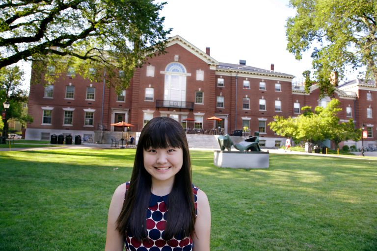HOLD FOR STORY SLUGGED CHINA GOING TO US HIGH SCHOOL BY DIDI TANG IN BEIJING, SCHEDULED TO MOVE IN LATE AUGUST - In this Thursday, July 10, 2014 photo, Lisa Li, a high school student at the U.S. prep school Lawrence Academy in Groton, Mass., stands in front of the Stephen Robert Campus Center on the Brown University Campus  in Providence, RI. (AP Photo/Stephan Savoia)
