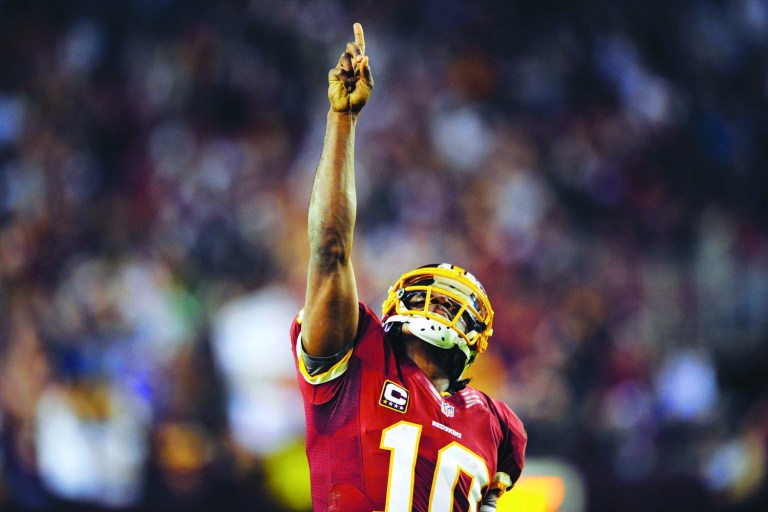 Nick Wass/AP
Quarterback Robert Griffin III had 235 total yards and threw a touchdown to lead the Redskins past the Giants on Monday night.