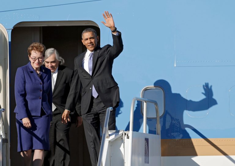 President Barack Obama, accompanied by Rep. Marcy Kaptur, D-Ohio and Energy Secretary Ernest Moniz, waves as they exit Air Force One at Cleveland Hopkins International Airport in Cleveland, Thursday, Nov. 14, 2013. Obama traveled to Cleveland to speak on the economy at the Arcelor Mittal steel mill. (AP Photo/Mark Duncan)