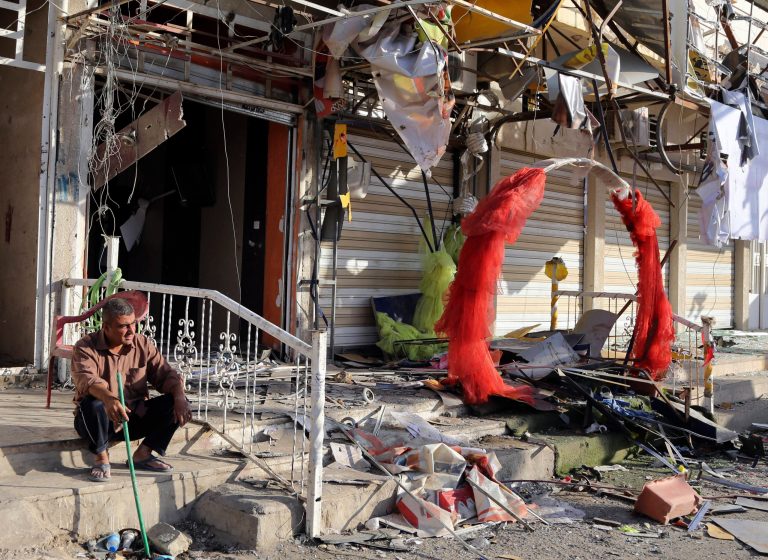A man sits in front of his shop that was damaged in a Saturday car bomb attack near a Kebab restaurant, in the mainly Shiite Habibiya neighborhood of Baghdad, Iraq, Sunday, May 11, 2014. A series of bombings on Saturday in Iraq killed and wounded scores of people, a day after army shelling killed many civilians and gunmen in the militant-held city of Fallujah, authorities said. (AP Photo/Karim Kadim)