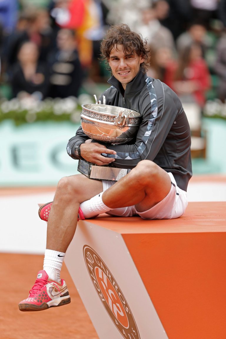   Rafael Nadal of Spain poses with the trophy after winning the mens final match against Novak Djokovic of Serbia at the French Open tennis tournament in Roland Garros stadium in Paris, Monday June 11, 2012. Rain suspended the final making it the first French Open not to end on Sunday since 1973. Nadal clinched his seventh title in four sets 6-4, 6-3, 2-6, 7-5, passing Sweden's Bjorn Borg as the all-time record-holder for French Open titles. (AP Photo/Bernat Armangue)  