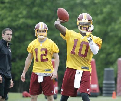 Jennifer Milbrett/The Washington ExaminerWhen quarterback Robert Griffin III wasn't working in drills, he spent much of the weekend conferring with the coaching staff or talking to new teammates.