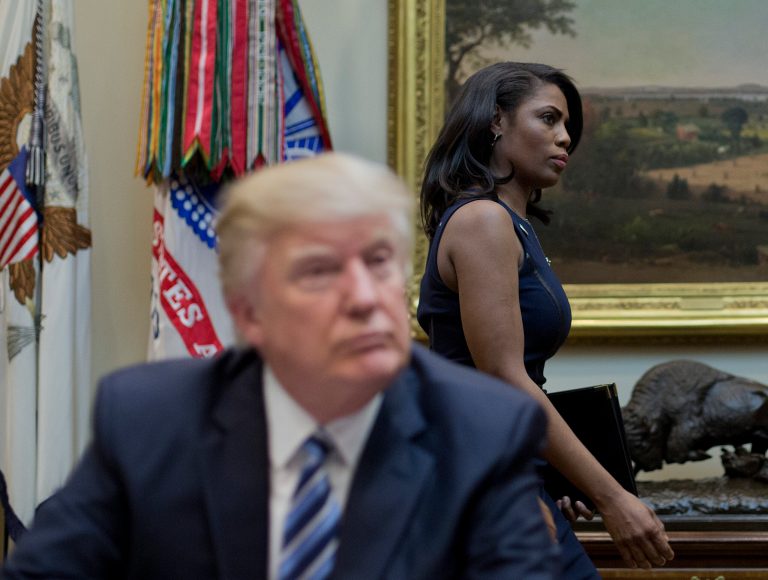 Former White House director of communications for the Office of Public Liaison Omarosa Manigault Newman, right, walks past President Donald Trump during a meeting on healthcare in the Roosevelt Room in March. (AP Photo/Pablo Martinez Monsivais)