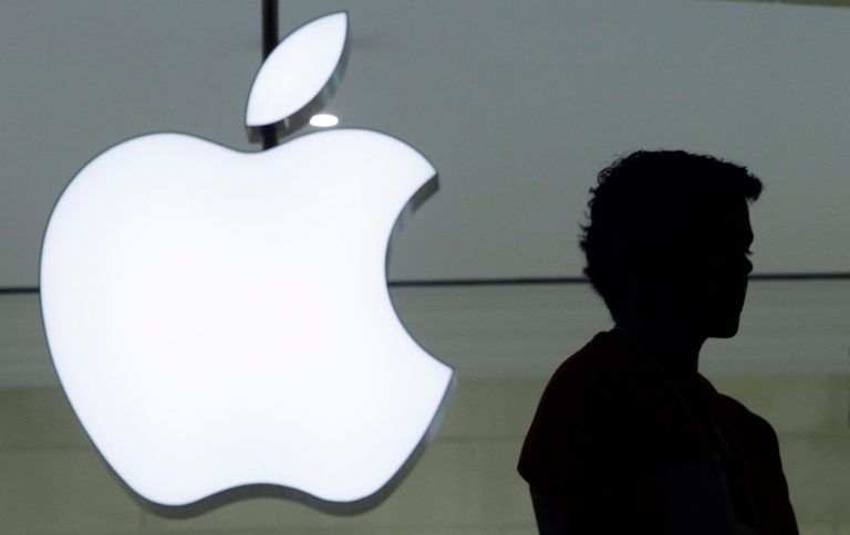 FILE - In a Wednesday, Dec. 7, 2011, file photo, a person stands near the Apple logo at the company's store in Grand Central Terminal, in New York. Apple will show off its newest products Sept. 9, 2014. The iPhone and iPad maker set the date in invitations mailed Thursday, Aug. 28, 2014, to reporters and others who typically come to see the unveiling of Apple's latest twists on technology. (AP Photo/Mark Lennihan, File)
