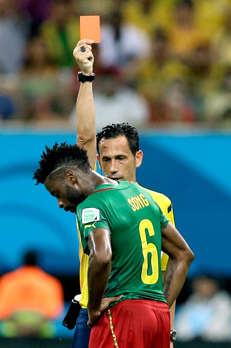 FILE - In this Wednesday, June 18, 2014 file photo, referee Pedro Proenca from Portugal gives a red card to Cameroon's Alex Song during the group A World Cup soccer match between Cameroon and Croatia at the Arena da Amazonia in Manaus, Brazil. Cameroon's football federation said late Monday, June 30, 2014, it will investigate allegations of match-fixing by its team at the World Cup and the possible existence of 