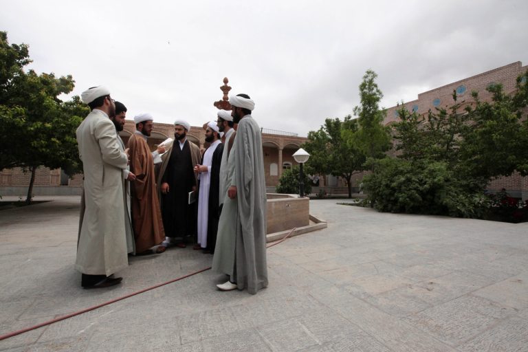 In this picture taken on Tuesday, May 6, 2013, Iranian clerics gather at the Masoumieh seminary in the eastern city of Birjand, Iran. When struggling families in the eastern Iranian city of Birjand take measure of Mahmoud Ahmadinejad's presidency in its waning weeks, it's not about his browbeating oratory against the West or his battles with Iran's ruling clerics. Instead, it's the rows of simple two-story homes on the city's outskirts that sharply improved their lives. (AP Photo/Vahid Salemi)