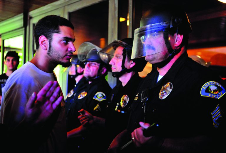 Demonstrators gather on the steps of Anaheim City Hall Tuesday, July 24, 2012, to protest the death of Manuel Diaz, 25, who died as a result of gunshot wounds sustained during a police pursuit by the Anaheim Police Department last Saturday. As many as 500 protesters and 250 police were involved in a fourth night of violence Tuesday. Seven hours of confrontations ended around 2 a.m. Wednesday. (AP Photo/The Orange County Register,Stuart Palley ) MAGS OUT; LOS ANGELES TIMES OUT