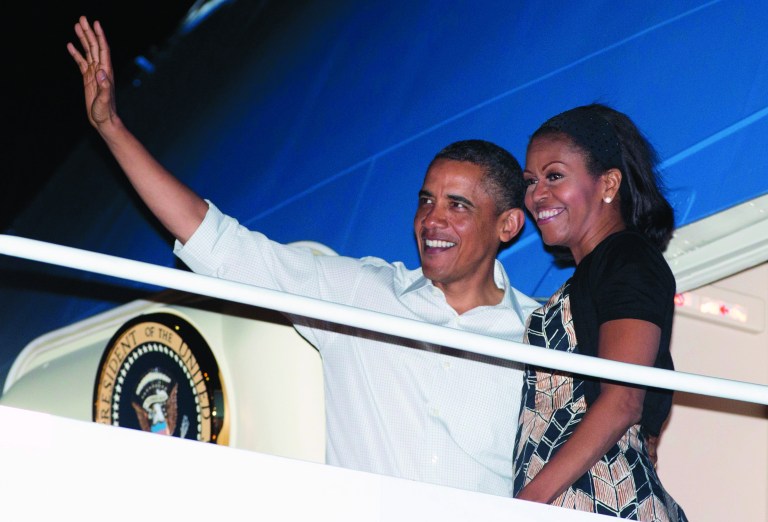 President Barack Obama and first lady Michelle Obama board Air Force One at Honolulu Joint Base Pearl Harbor-Hickam, Saturday, Jan. 5, 2013, in Honolulu, en route to Washington after their holiday vacation. (AP Photo/Carolyn Kaster)