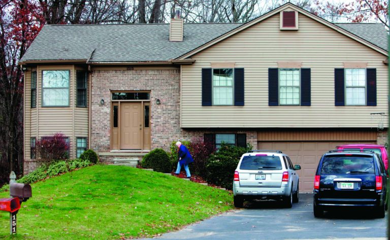 CORRECTS SOURCE TO DETROIT FREE PRESS - A visitor comes to the home where the suspected I-96 shooter was living, in Wixom, Mich., Tuesday, Nov. 6, 2012. Authorities say a 43-year-old man was arrested Monday in connection with dozens of shootings across four Michigan counties that resulted in at least one injury. Authorities investigating a shooting spree that included 24 incidents and one injury in four counties executed a search warrant at the southeast Michigan home, police said. (AP Photo/Detroit Free Press, Eric Seals) DETROIT NEWS OUT; NO SALES