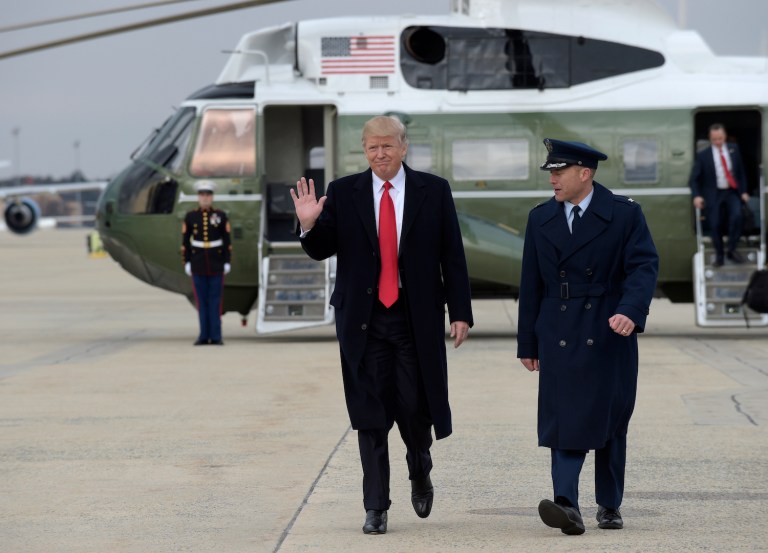 Spectators lined streets in Palm Beach to welcome the president at his resort. (AP Photo/Susan Walsh)