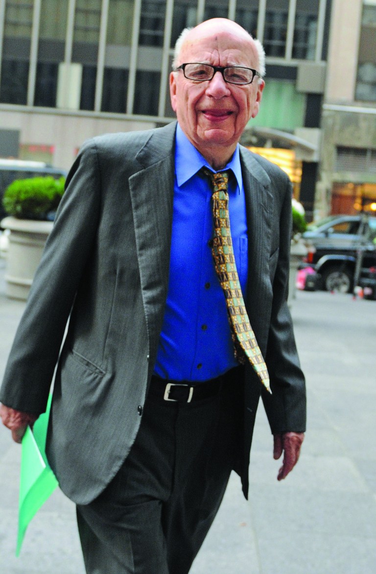 FILE - In this July 22, 2011 file photo, Chairman and Chief Executive Officer of News Corporation Rupert Murdoch enters the News Corp. building, in New York. Media mogul Rupert Murdoch has resigned from a number of News Corp. subsidiary boards in Britain and the United States, a spokeswoman confirmed Saturday, July 21, 2012. (AP Photo/Louis Lanzano, File)