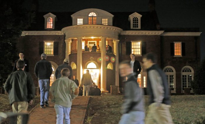 In this Thursday, Jan. 15, 2015 photo, University of Virginia students walk to fraternities at the start of rush week at the University of Virginia in Charlottesville, Va. (AP Photo/Steve Helber)