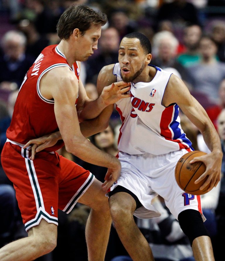   Detroit Pistons forward Tayshaun Prince (22) takes a hit in the throat from Milwaukee Bucks forward Mike Dunleavy while going to the basket in the first half of an NBA basketball game, Sunday, Dec. 30, 2012, in Auburn Hills, Mich. (AP Photo/Duane Burleson)  