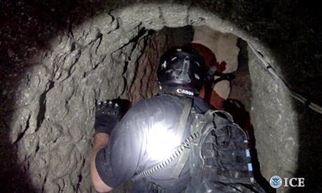 An Oct. 31, 2013, photo released by U.S. Immigration and Customs Enforcement shows agents in a tunnel designed to smuggle drugs from Tijuana, Mexico, to San Diego. (AP Photo/U.S. Immigration and Customs Enforcement, Paul Caffrey)