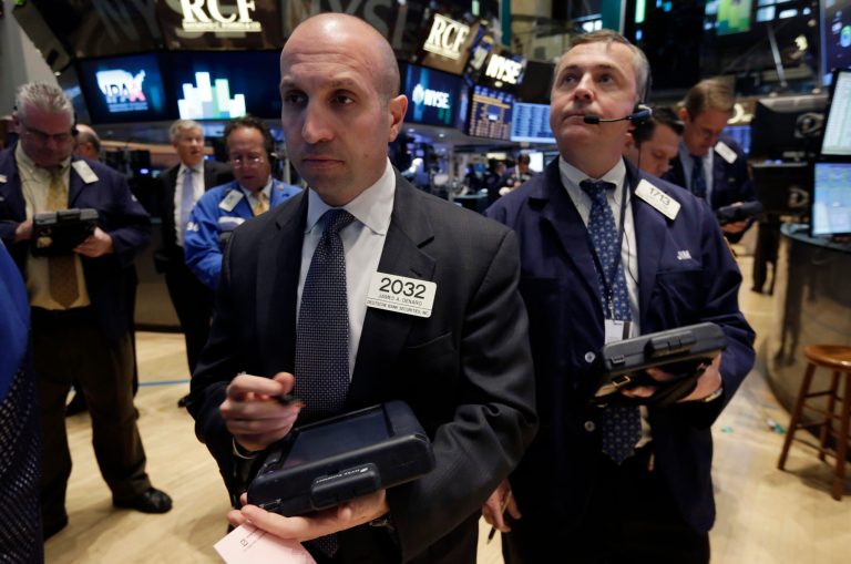 Trader James Denaro, center, works on the floor of the New York Stock Exchange, Monday, April 7, 2014.  Stocks are starting out the week the same way they ended the last one, down. (AP Photo/Richard Drew)