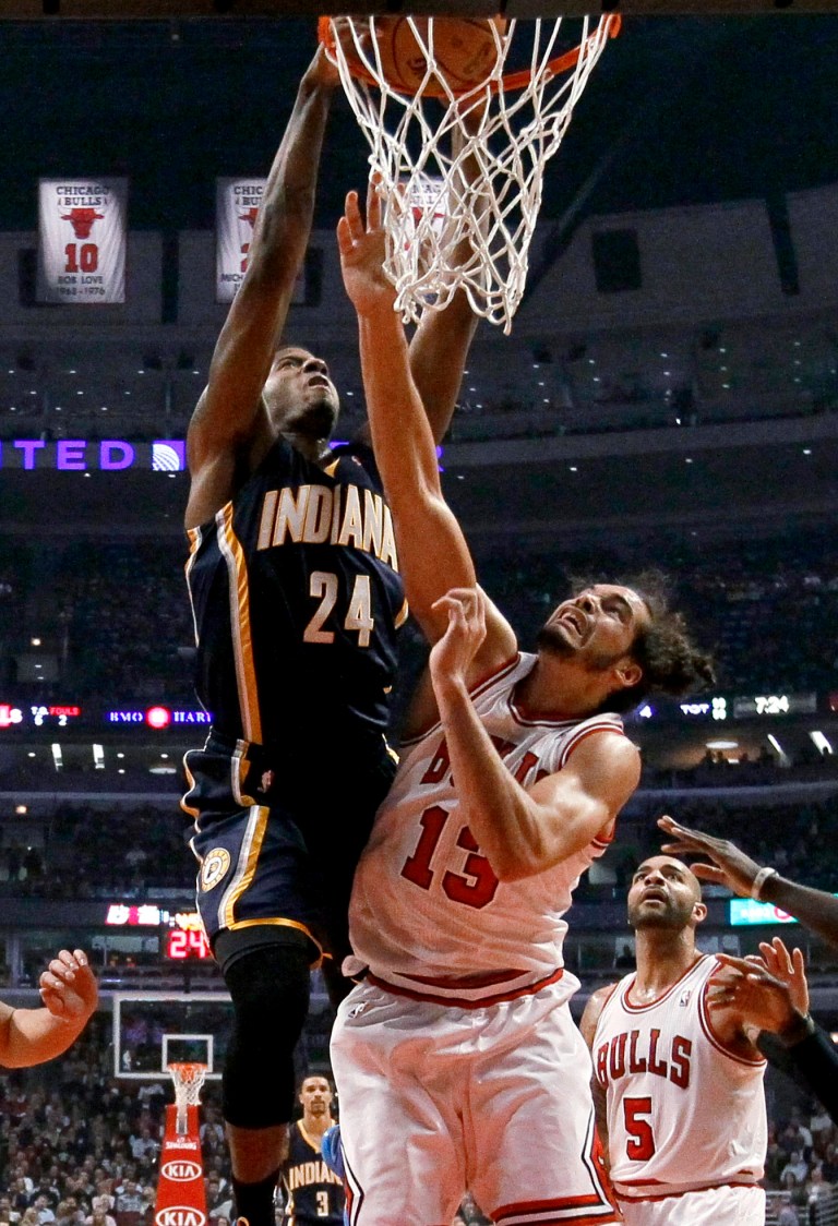   Indiana Pacers forward Paul George (24) dunks over Chicago Bulls center Joakim Noah (13) during the first half of an NBA basketball game Tuesday, Dec. 4, 2012, in Chicago. (AP Photo/Charles Rex Arbogast)  