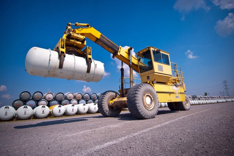 This undated photo provided by United States Enrichment Corp shows Ronnie Kineman, a member of USEC's cylinder handling crew, moving a  Department of Energy-owned depleted uranium 
