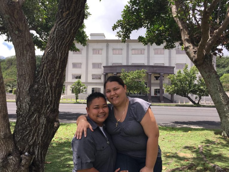 Loretta M. Pangelinan, left, and Kathleen M. Aguero, stand in front of the U.S. District Court in Hagatna, Guam. The couple, who have been together for more than nine years, said they filed a lawsuit against the Government of Guam for violating their constitutional rights of equal protection and due process at the U.S. District Court in Hagatna, Guam. (AP Photo/Grace Garces Bordallo)